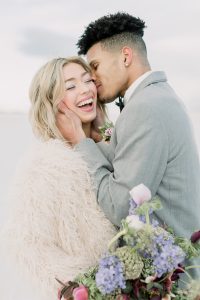 A couple ont their wedding day at the Salt Flats, in Utah Cotton Candy Skies Elopement Styled Shoot over the Bonneville Salt Flats