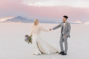A couple ont their wedding day at the Salt Flats, in Utah Cotton Candy Skies Elopement Styled Shoot over the Bonneville Salt Flats