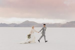 A couple ont their wedding day at the Salt Flats, in Utah Cotton Candy Skies Elopement Styled Shoot over the Bonneville Salt Flats