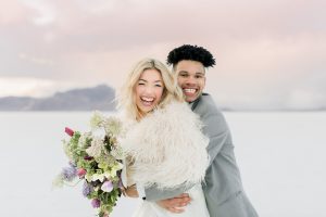 A couple ont their wedding day at the Salt Flats, in Utah Cotton Candy Skies Elopement Styled Shoot over the Bonneville Salt Flats