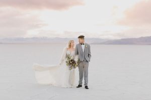 A couple ont their wedding day at the Salt Flats, in Utah Cotton Candy Skies Elopement Styled Shoot over the Bonneville Salt Flats
