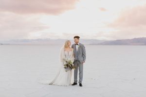 A couple ont their wedding day at the Salt Flats, in Utah Cotton Candy Skies Elopement Styled Shoot over the Bonneville Salt Flats