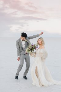 A couple ont their wedding day at the Salt Flats, in Utah Cotton Candy Skies Elopement Styled Shoot over the Bonneville Salt Flats