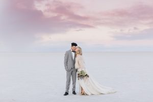 A couple ont their wedding day at the Salt Flats, in Utah Cotton Candy Skies Elopement Styled Shoot over the Bonneville Salt Flats