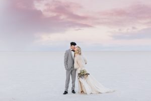 A couple ont their wedding day at the Salt Flats, in Utah Cotton Candy Skies Elopement Styled Shoot over the Bonneville Salt Flats