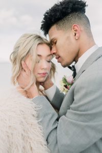 A couple ont their wedding day at the Salt Flats, in Utah Cotton Candy Skies Elopement Styled Shoot over the Bonneville Salt Flats